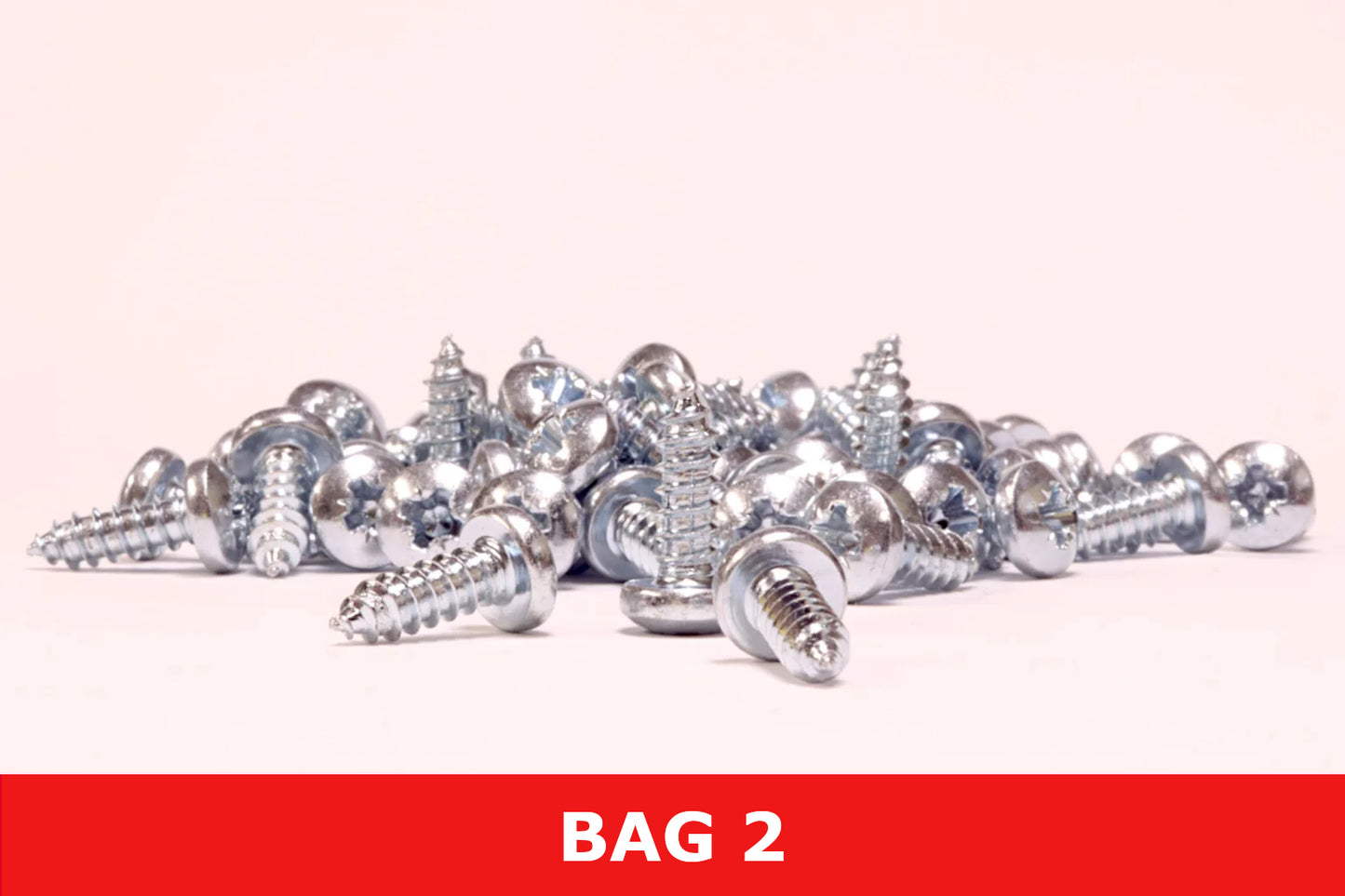 Pile of silver metal Phillips screws for outdoor shed assembly, labeled as Bag 2