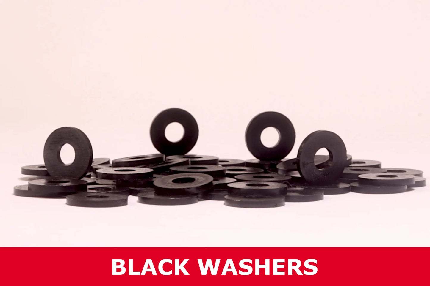 Pile of black metal washers for outdoor storage shed assembly on a white background